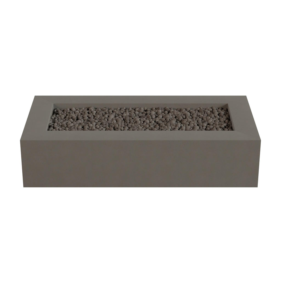 A rectangular concrete planter filled with small rocks or pebbles.