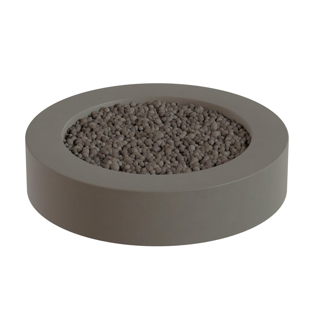 A gray, circular planter filled with small, round stones or pebbles.