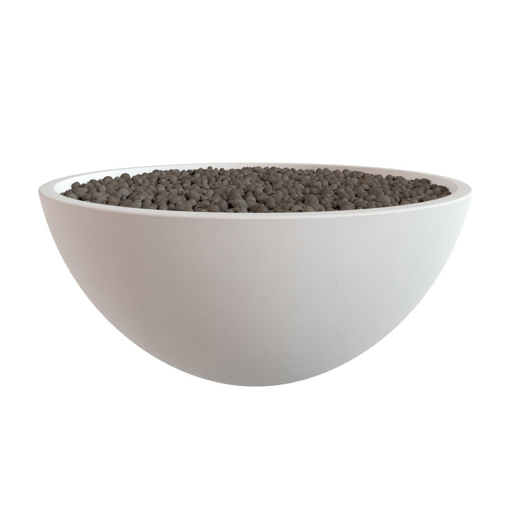 A white bowl filled with small, dark-colored objects, possibly gravel or pebbles.