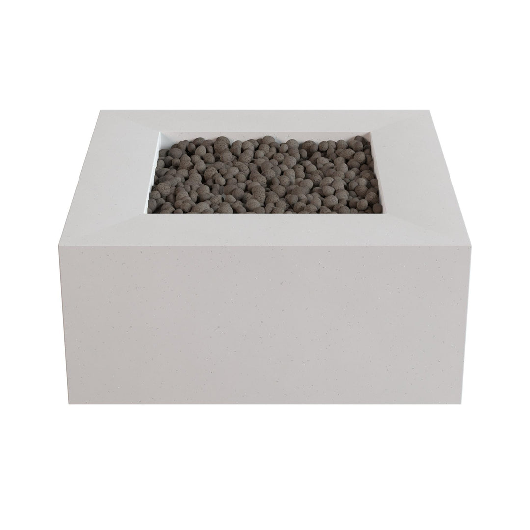 a white rectangular structure with a small opening in the top left corner, filled with small gray stones or pebbles.