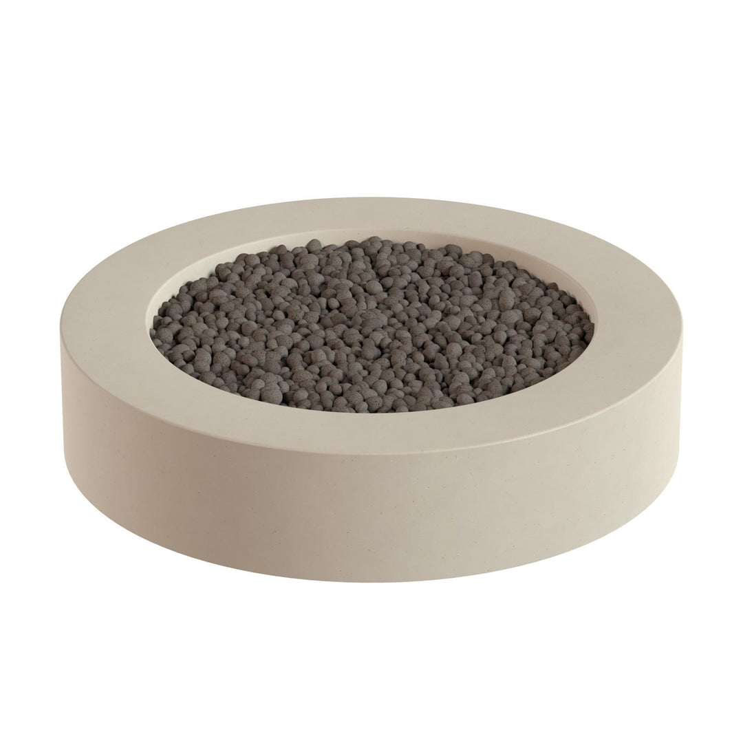 A round, beige-colored container filled with small, dark-colored stones or pebbles.