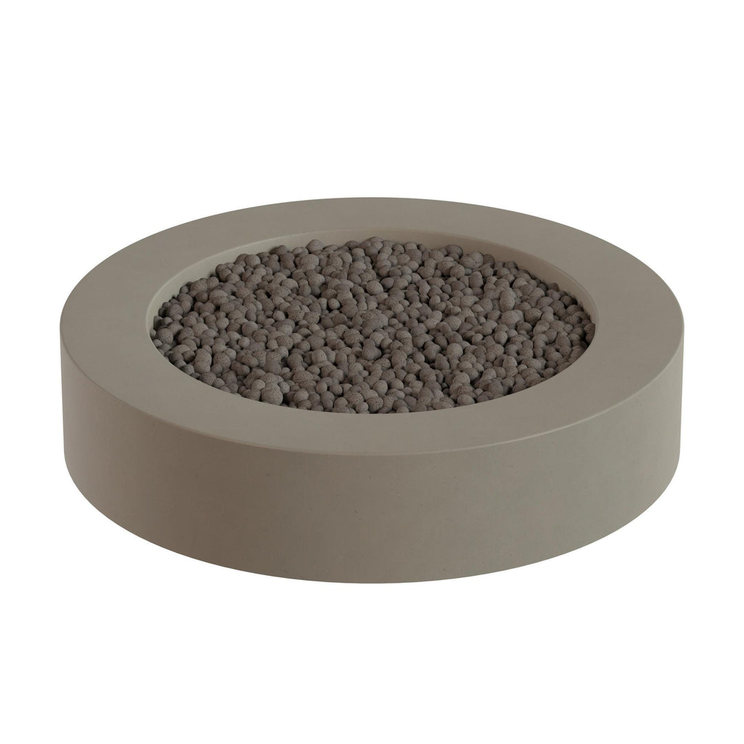 A round, gray-colored planter filled with small, round stones or pebbles.