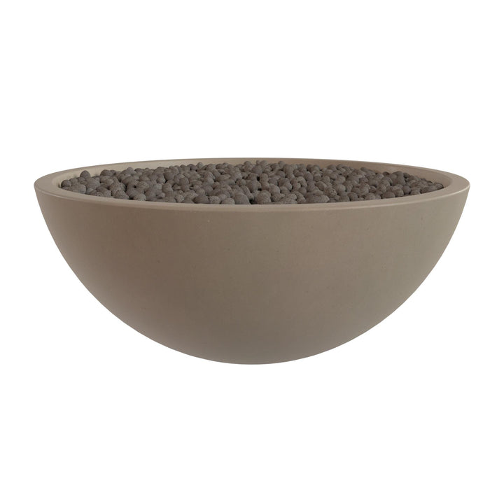 A large, round, beige bowl filled with small, dark-colored stones or pebbles.