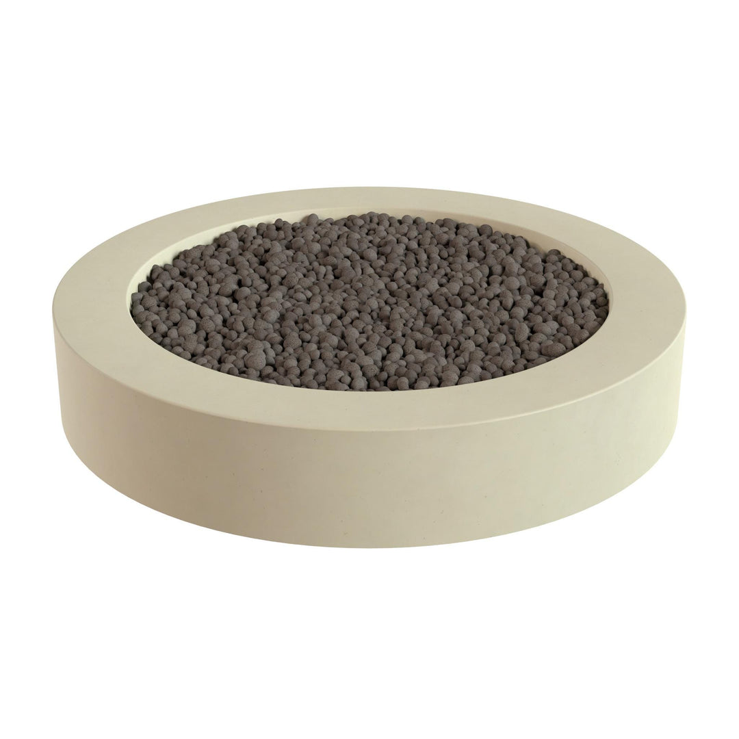a round, beige-colored container filled with small, dark-colored stones or pebbles.