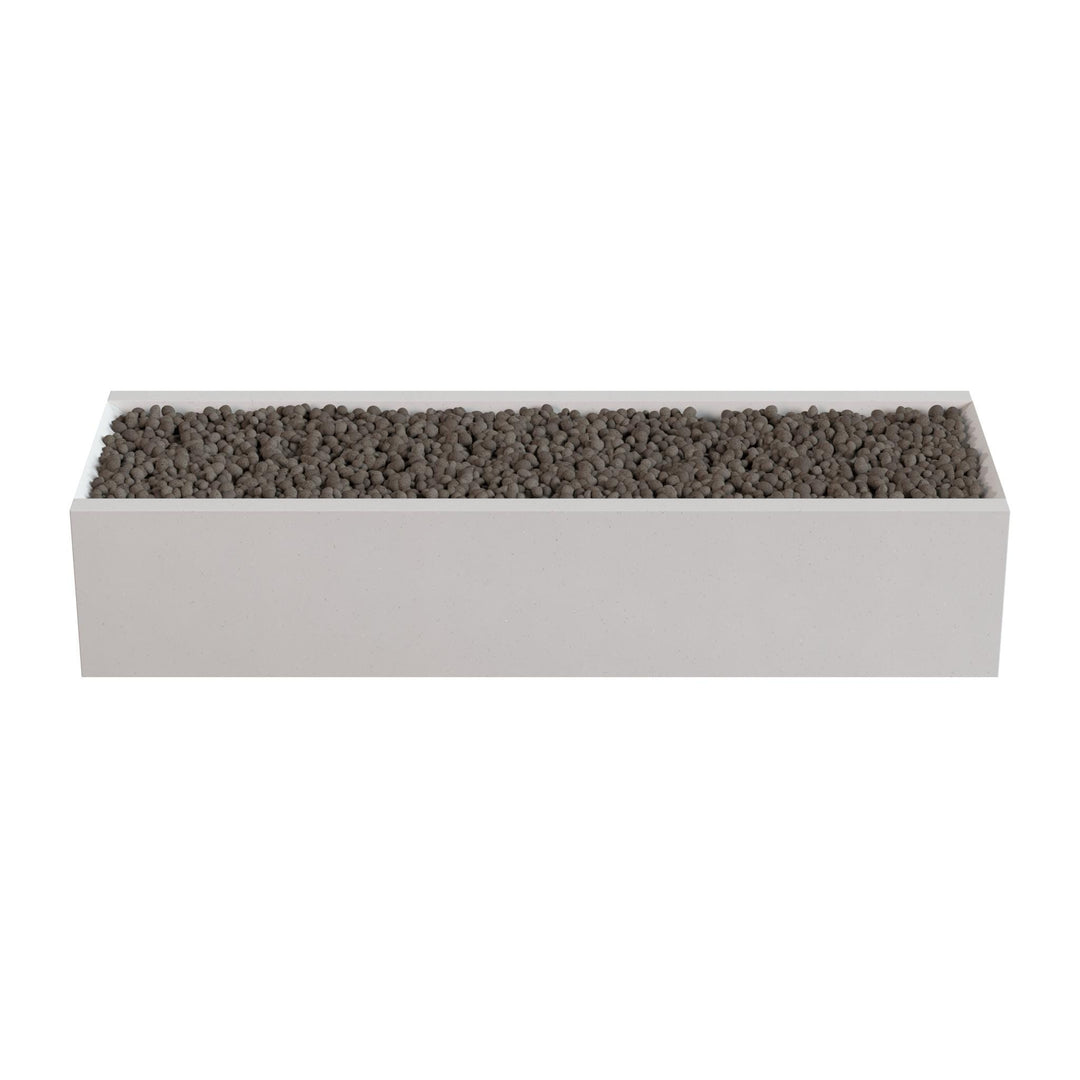 A rectangular white planter box filled with small dark rocks or pebbles.