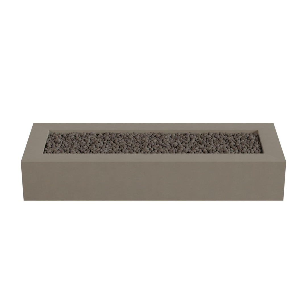 A rectangular concrete planter box filled with small rocks or pebbles.