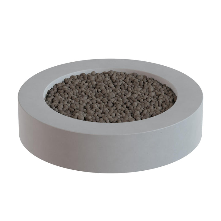A white, circular planter filled with small, round stones or pebbles.