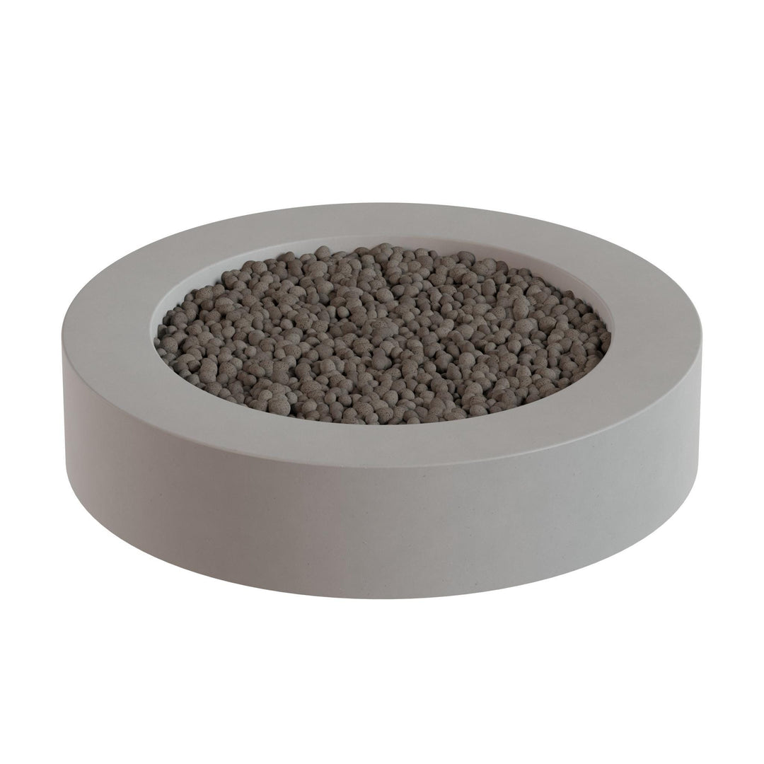 A gray, circular planter filled with small, round stones or pebbles.