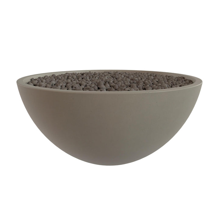 A large, round bowl filled with small, dark-colored stones or pebbles.