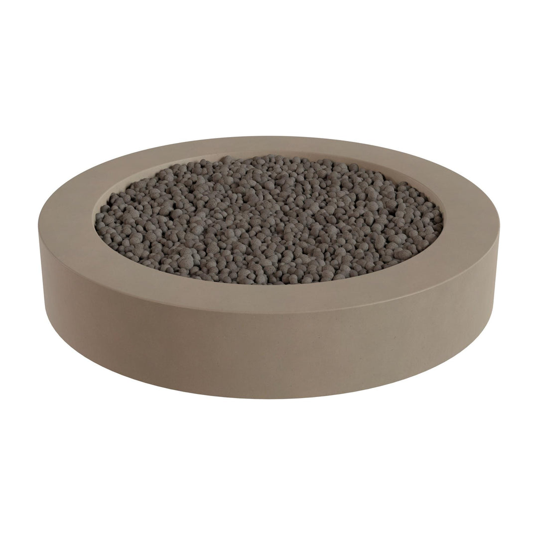 a round, beige-colored container filled with small, dark-colored stones or pebbles.