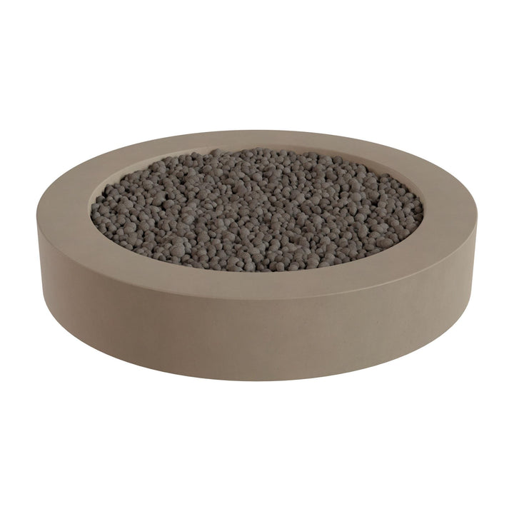 a round, beige-colored container filled with small, dark-colored stones or pebbles.