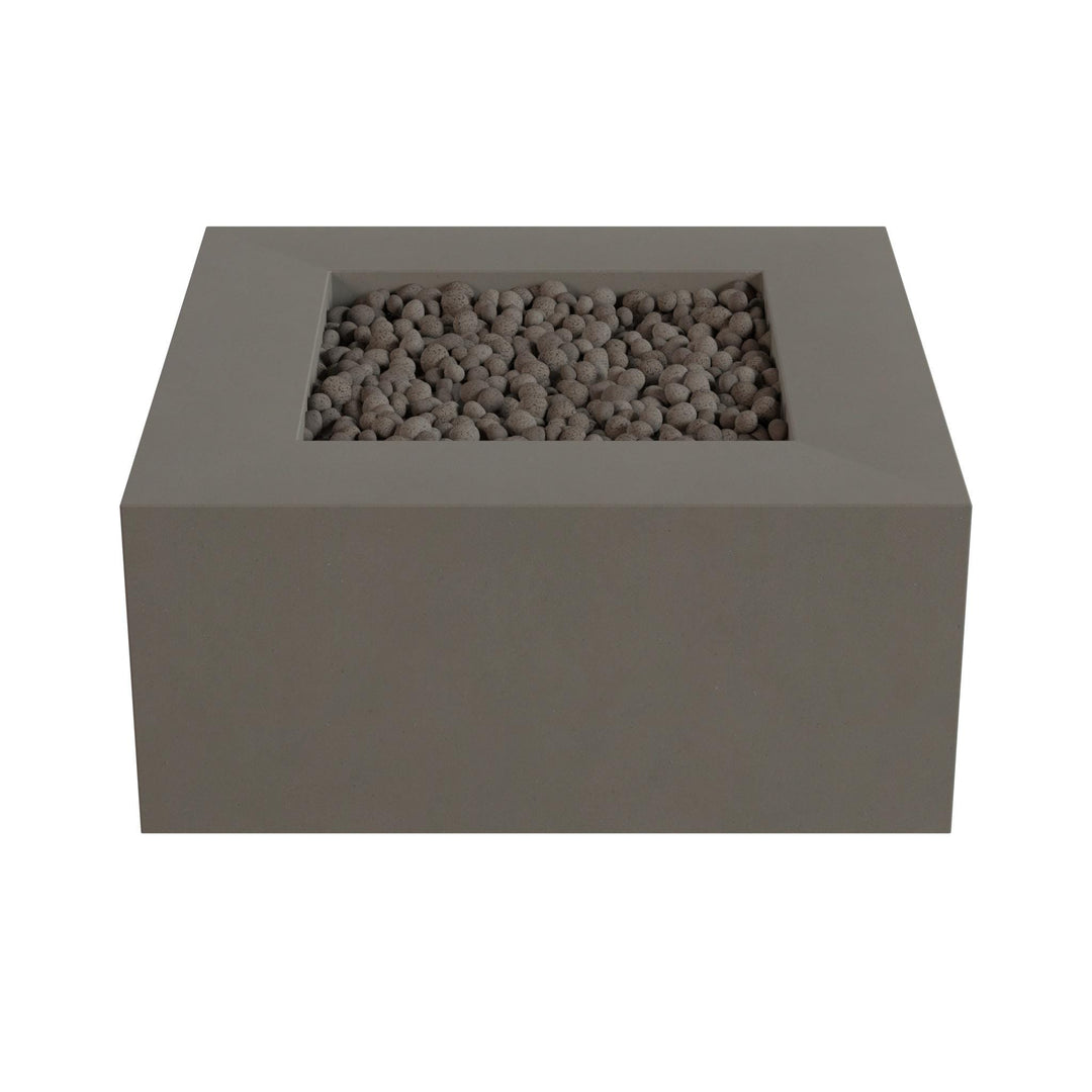A rectangular gray stone or brick structure with a small opening or opening in the center, filled with small stones or pebbles.