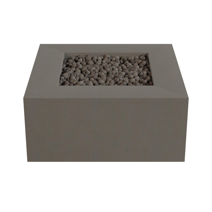 A rectangular gray stone or brick structure with a small opening or opening in the center, filled with small stones or pebbles.