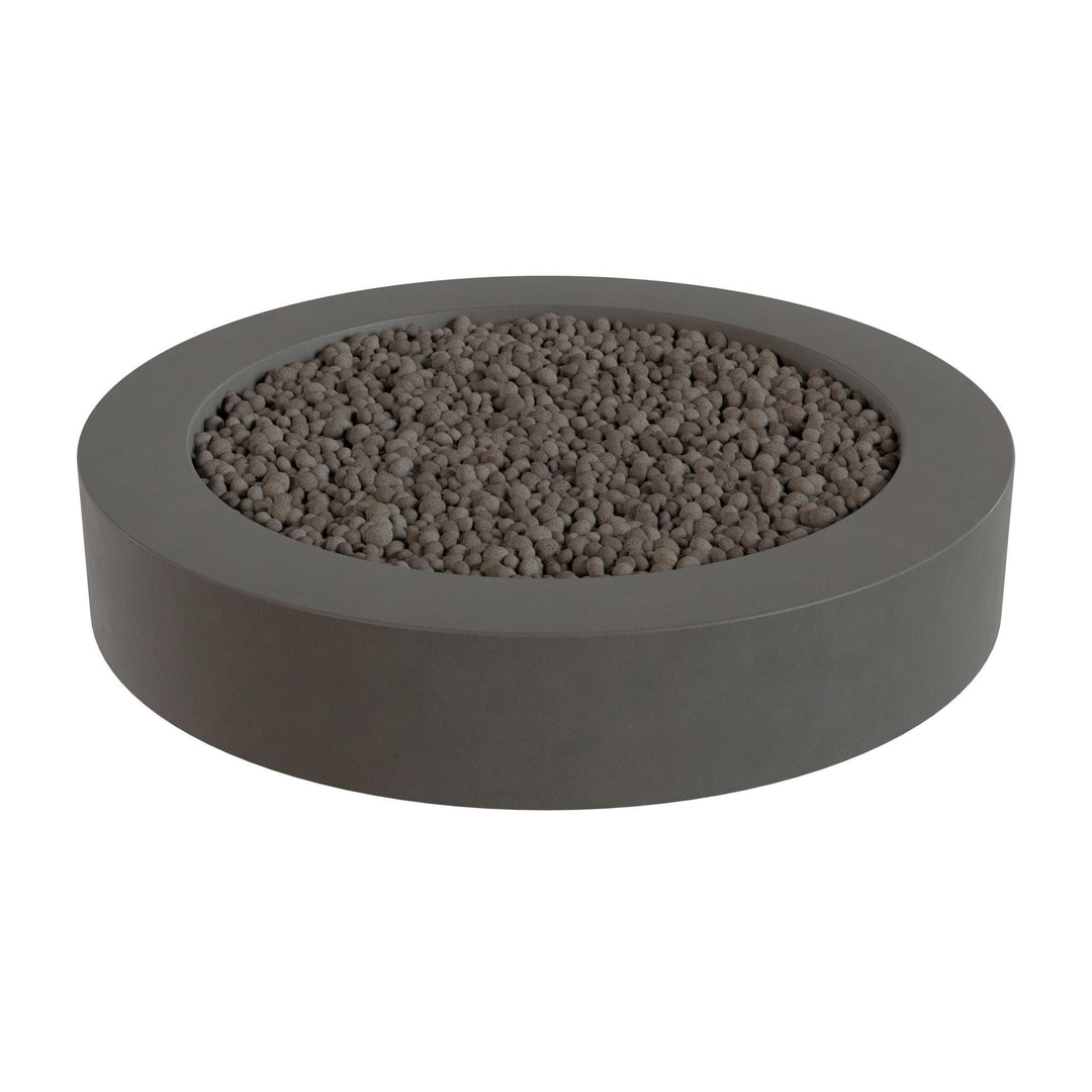 a gray, circular planter filled with small rocks or pebbles.