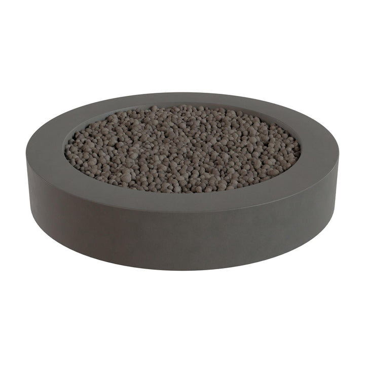 a gray, circular planter filled with small rocks or pebbles.