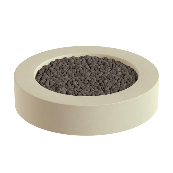 a round, beige-colored container filled with small, dark-colored stones or pebbles.