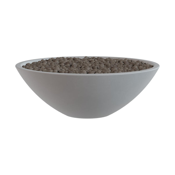 A white bowl filled with small brown objects, possibly nuts or seeds.