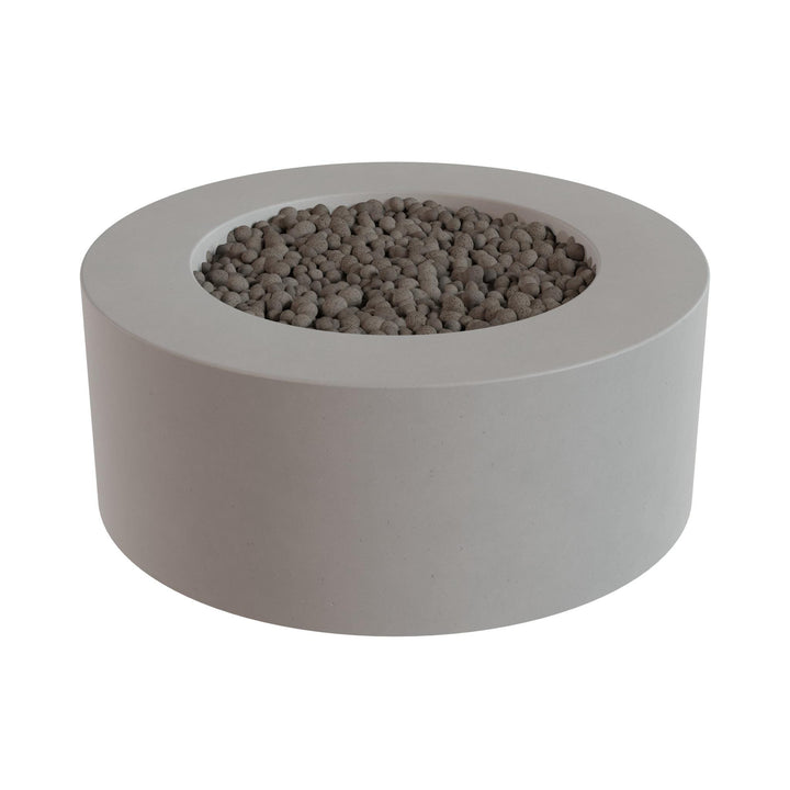 a gray, circular planter filled with small rocks or pebbles.