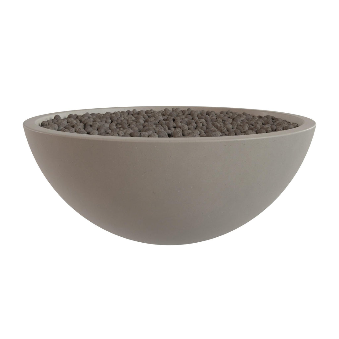 A large, round, gray bowl filled with small, dark-colored stones or pebbles.