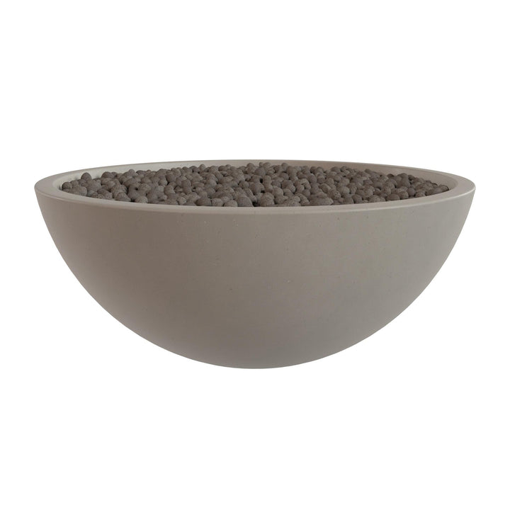 A large, round, gray bowl filled with small, dark-colored stones or pebbles.