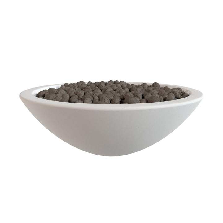 A white bowl filled with small, dark-colored objects, possibly gravel or pebbles.