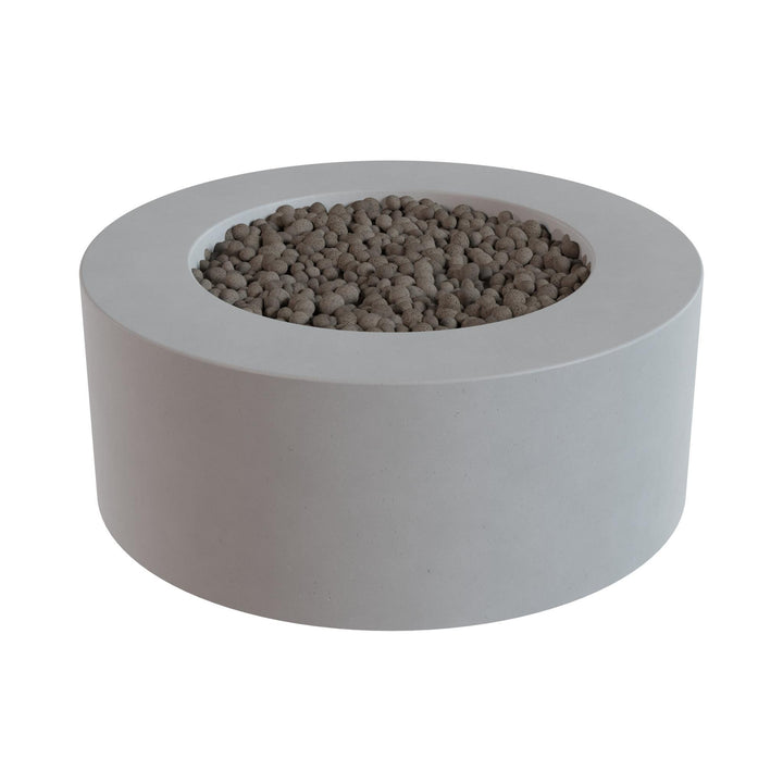 a gray, circular planter filled with small, round stones or pebbles.