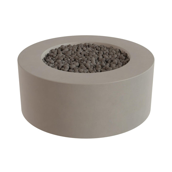 a round concrete planter with a hole in the center, filled with small gray stones or pebbles.
