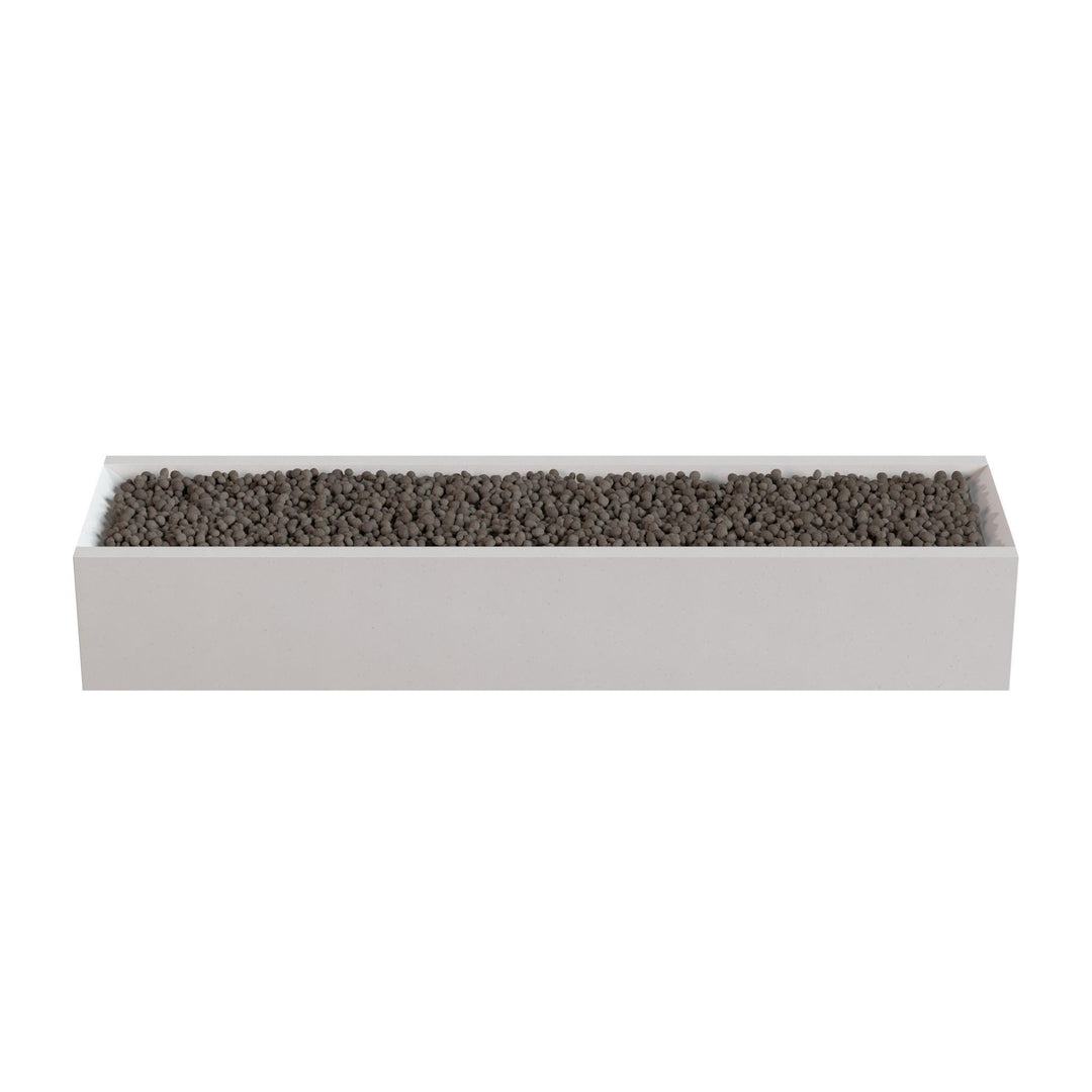 A rectangular white planter box filled with small dark-colored stones or pebbles.