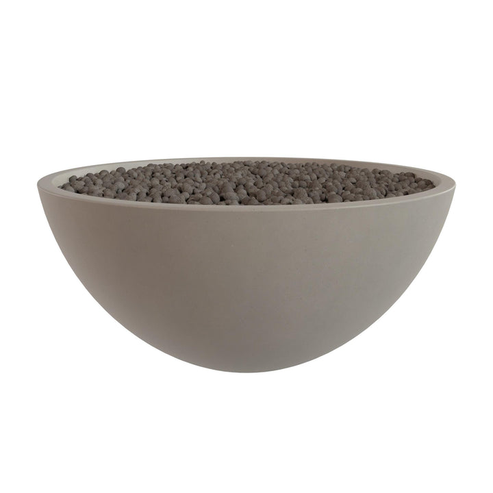 A large, round bowl filled with small, dark-colored stones or pebbles.