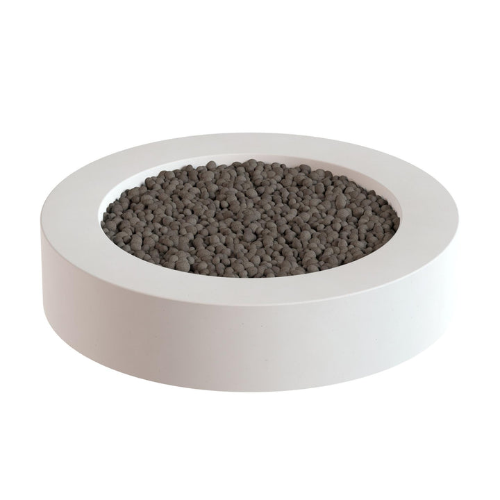 a white circular container filled with small, dark-colored objects, which appear to be pebbles or stones.