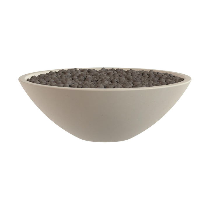 A white bowl filled with small, dark-colored objects, possibly gravel or pebbles.