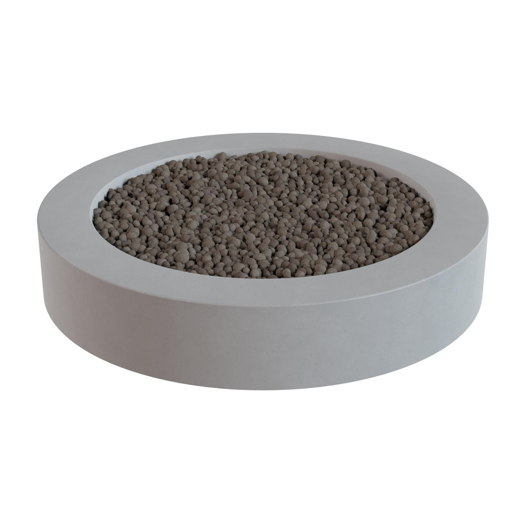 a white, circular planter filled with small, round stones or pebbles.