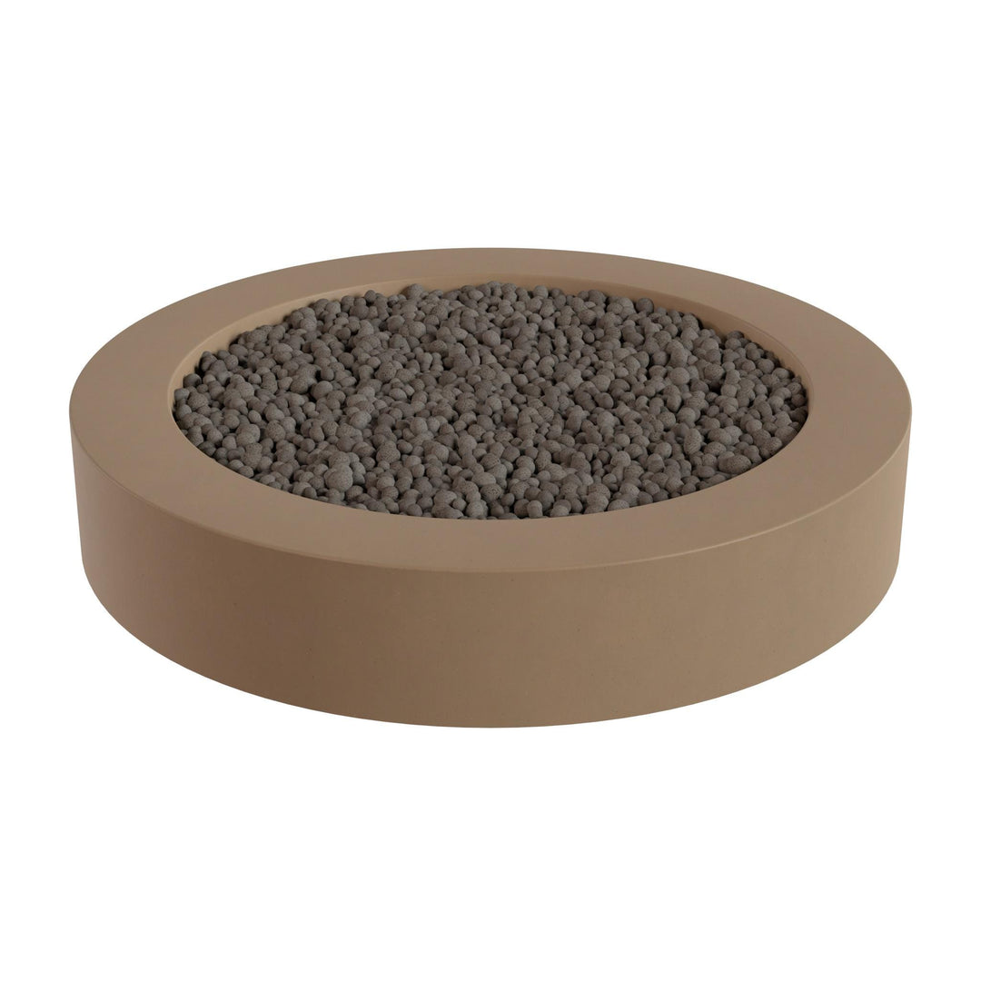 a round, beige-colored container filled with small, dark-colored stones or pebbles.