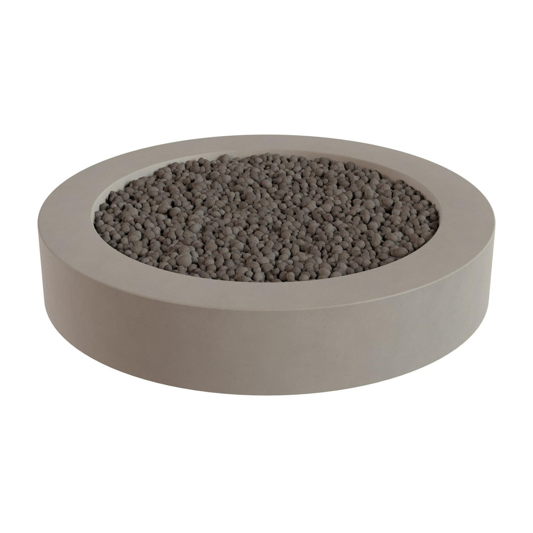 a round concrete planter filled with small gray stones or pebbles.