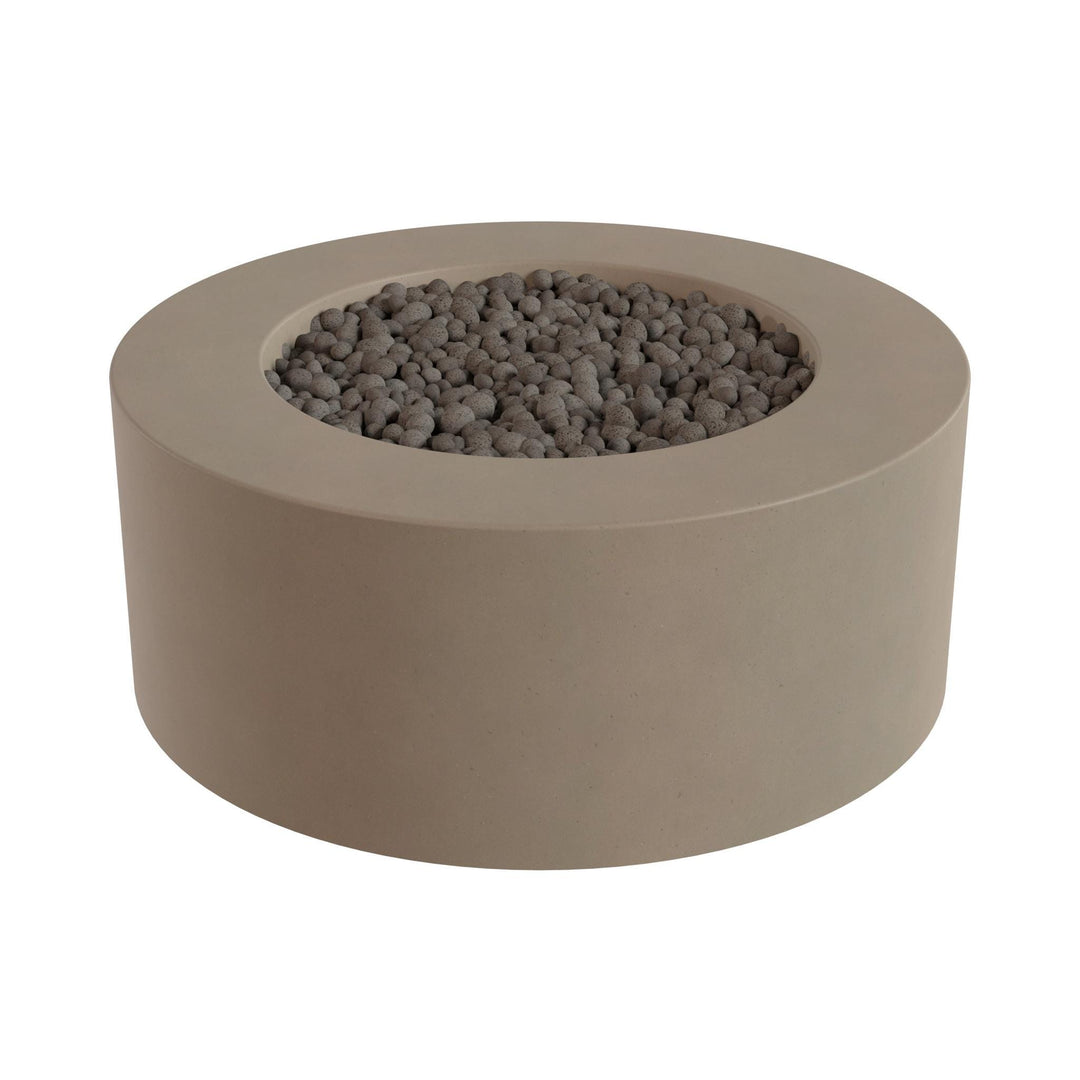 a round, beige-colored fire pit or planter filled with small gray stones or pebbles.